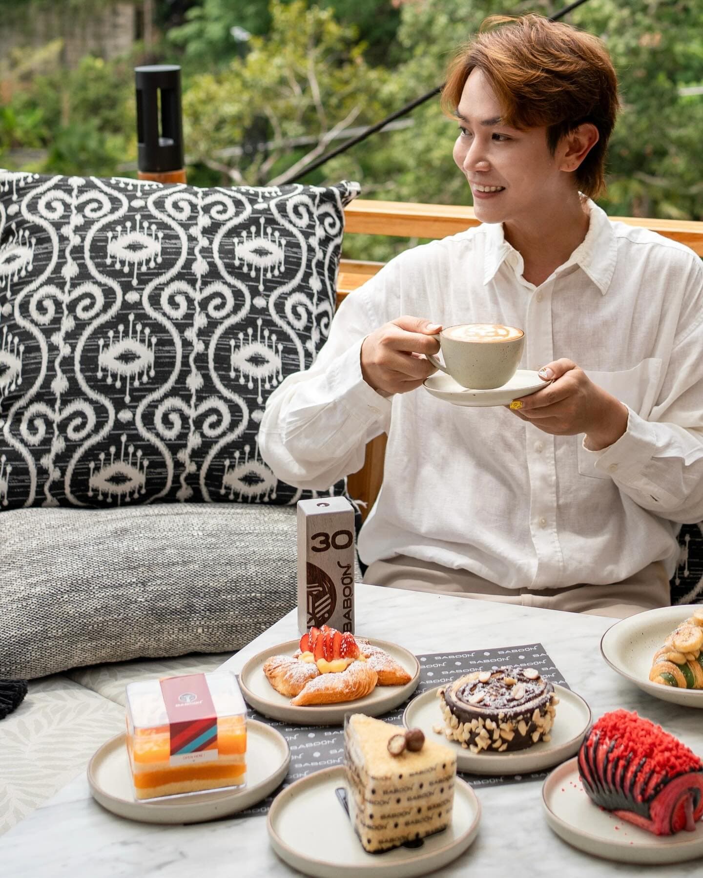 A guest enjoying coffee and pastries at Baboon