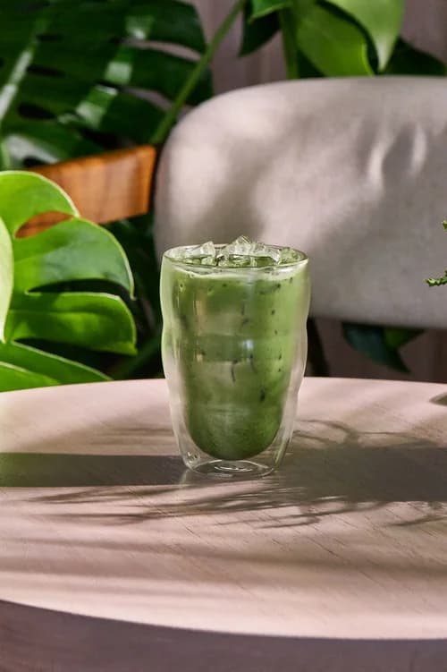 Iced green matcha latte in a tall glass at Baboon