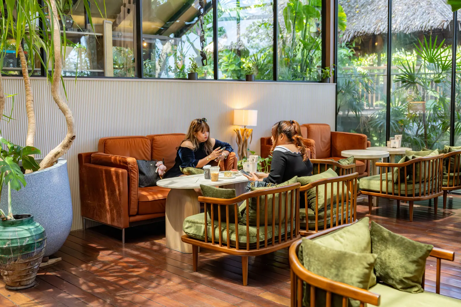 Guests enjoying drinks in Baboon's plant-filled seating area