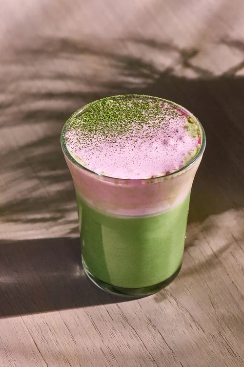 Green matcha drink topped with a pale pink layer