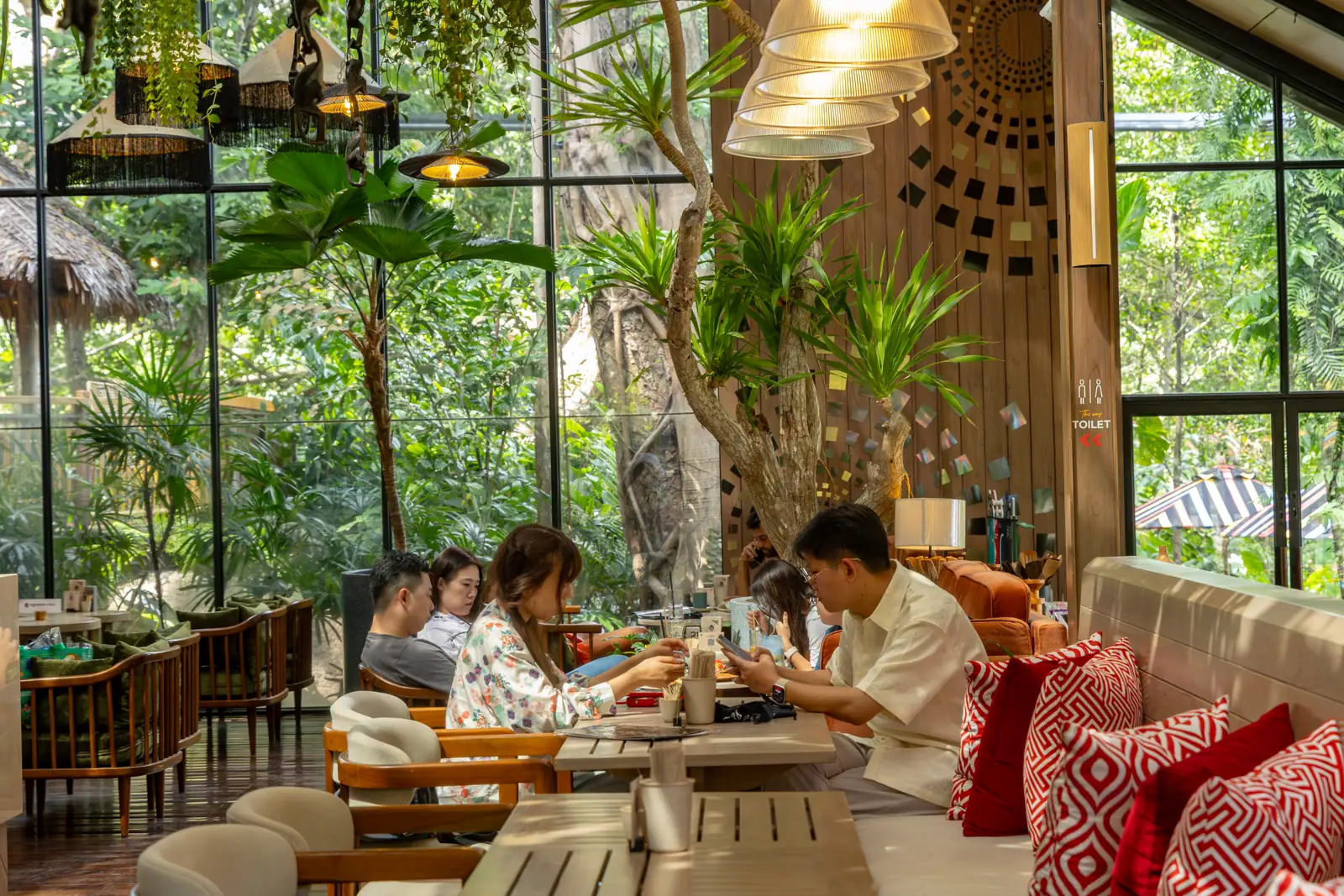 Guests drinking and talking beside Baboon's large windows